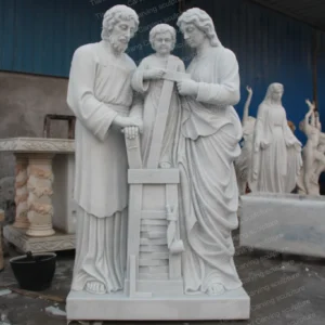 White marble sculpture of three members of the Holy Family (Saint Joseph carpentry theme)