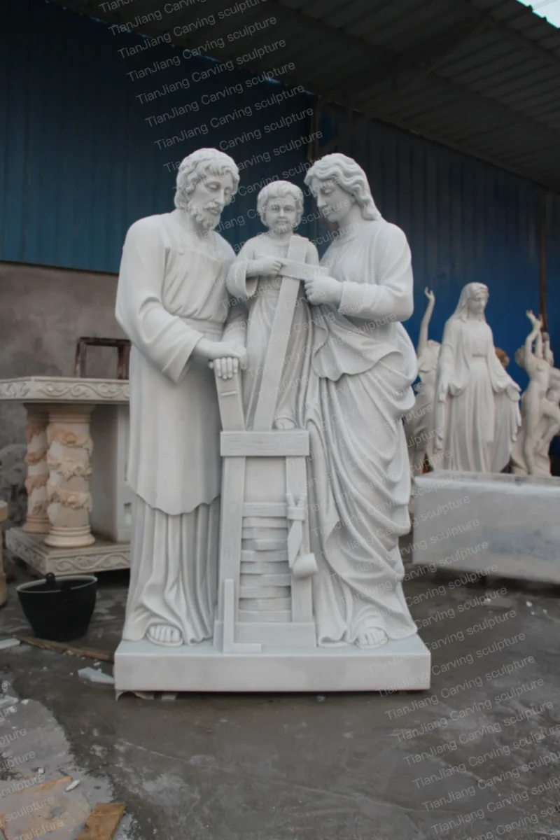 22498bc4-31ed-434c-bb06-2b6a3fe0f600.webp White marble sculpture of three members of the Holy Family (Saint Joseph carpentry theme)