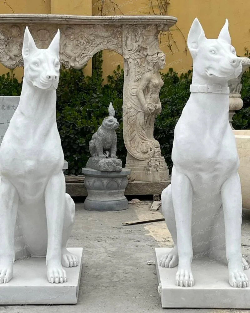 22b6ccee-6da3-41c9-9ff0-a9c0cd21cd07.webp White marble Doberman pinscher stone sculpture (pair)
