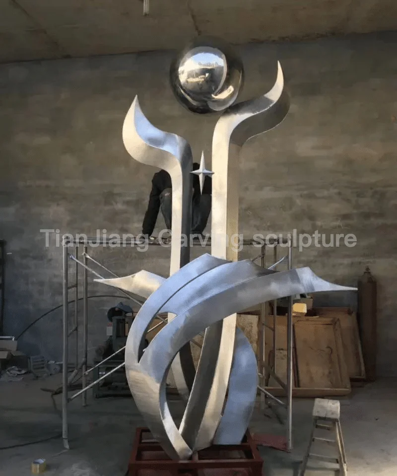 2c596999-614f-407a-b755-a96d3e7342b5.webp Stainless Steel Abstract Torch Star Sculpture
