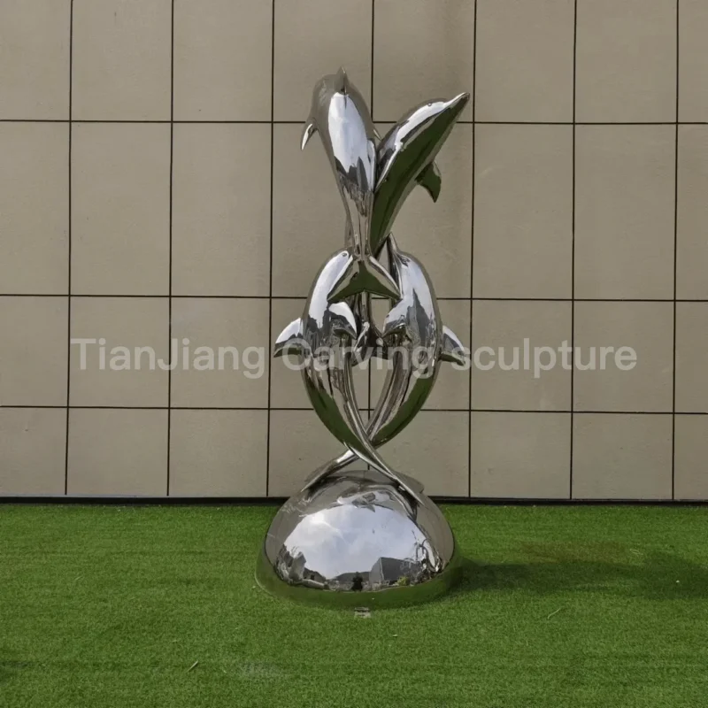 30f1a5c3-43b3-4f66-8436-708e6952491d.webp Stainless steel mirror sculpture of dolphins leaping