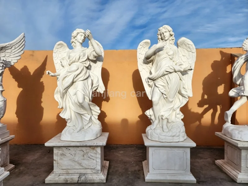 4e996890-36a1-4d2d-aee9-6170b7726200.webp White marble European-style stone carvings of angel figures holding spears (pair)
