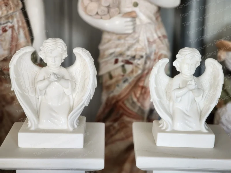 c89bd1f9-fd10-4723-b29f-f0e702f5dd25.webp White marble kneeling cherub sculptures (pair)