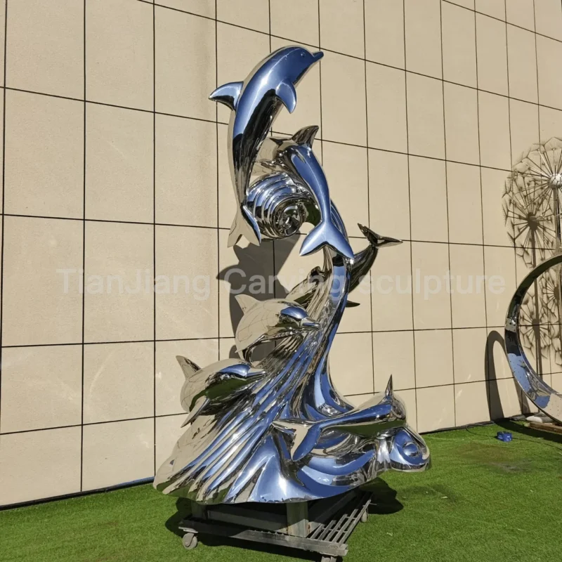 dcc80081-92fb-47b3-8221-d259b3ff6ee9.webp Stainless steel mirror dolphin wave sculpture