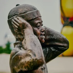 Cast copper sculpture of child covering ears