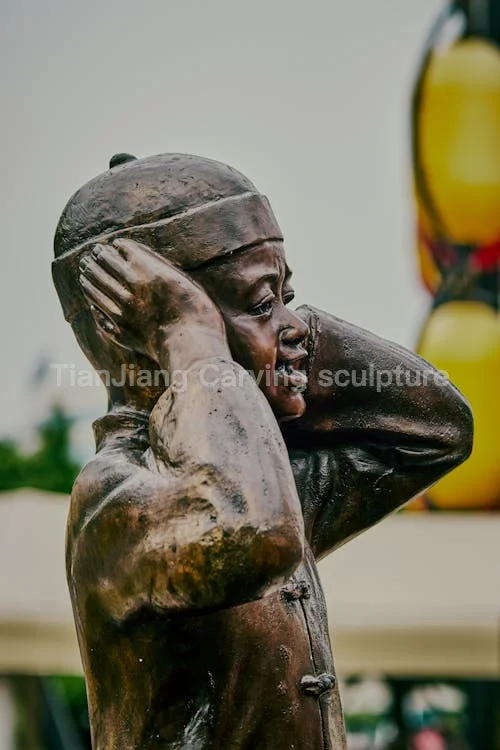 f2231efd-7a62-49d0-8b8d-9fb930a7c2ae.webp Cast copper sculpture of child covering ears