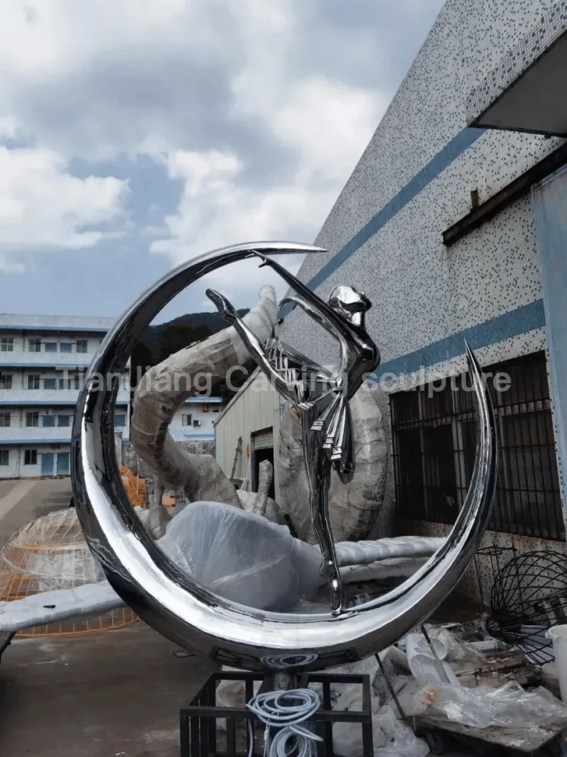 faf2a6fb-1553-4164-bc99-5fbde7ff92f6.webp Stainless steel mirror ballet dancer moon sculpture